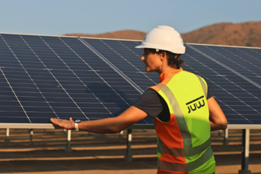Woman standing in front of a solar panel by JUWI