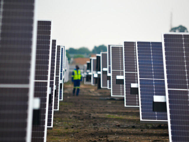 A Juwi employee is working at a solar park.